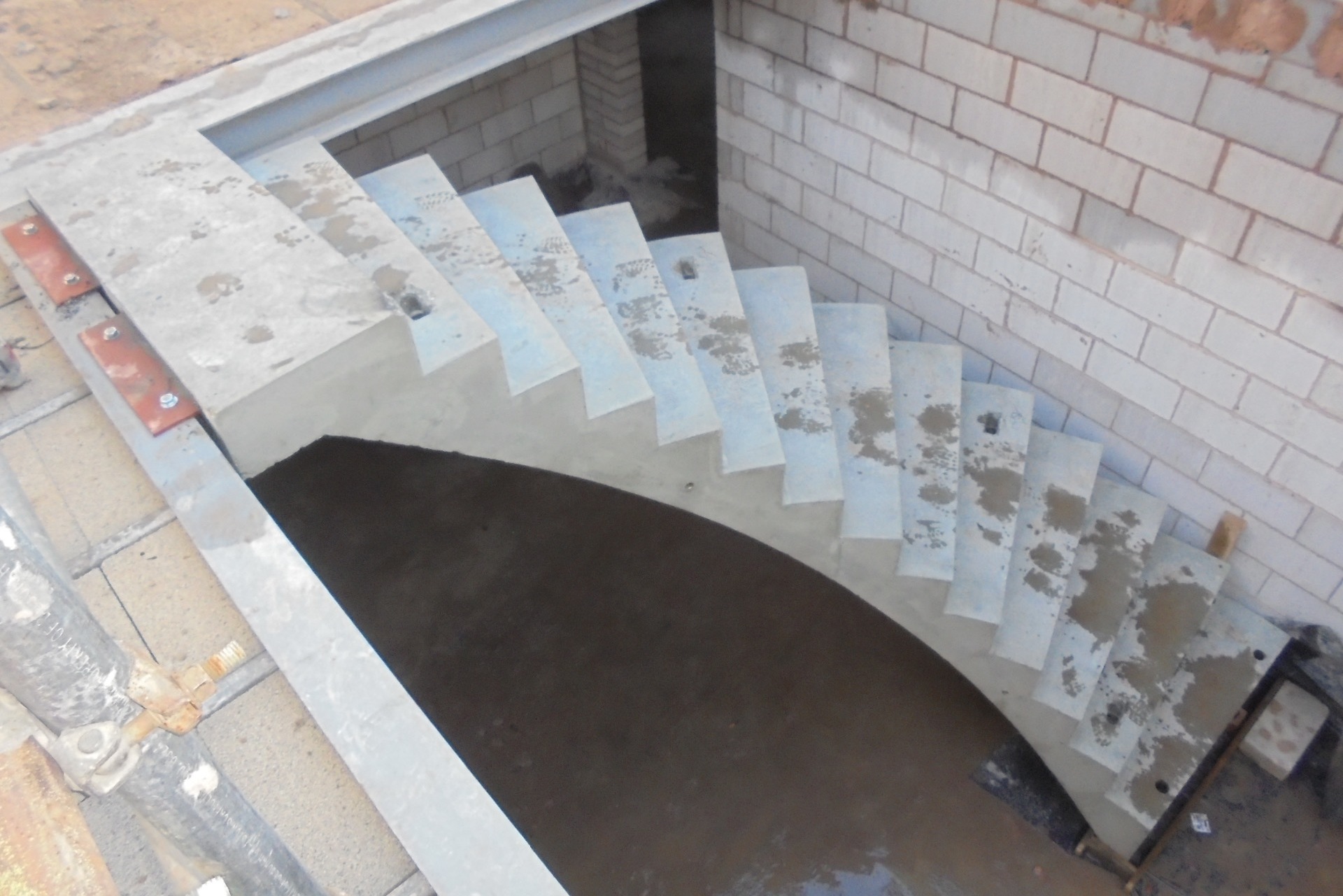 curved precast concrete stair installed to steel frame