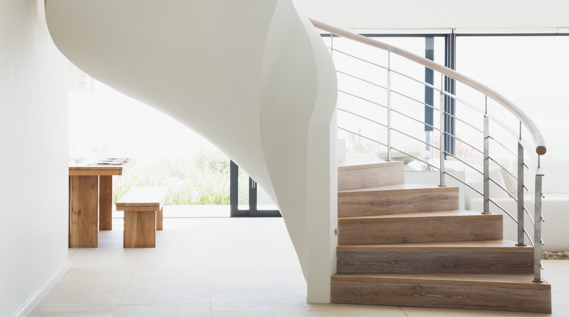 sweeping luxury curved stair with wooden treads