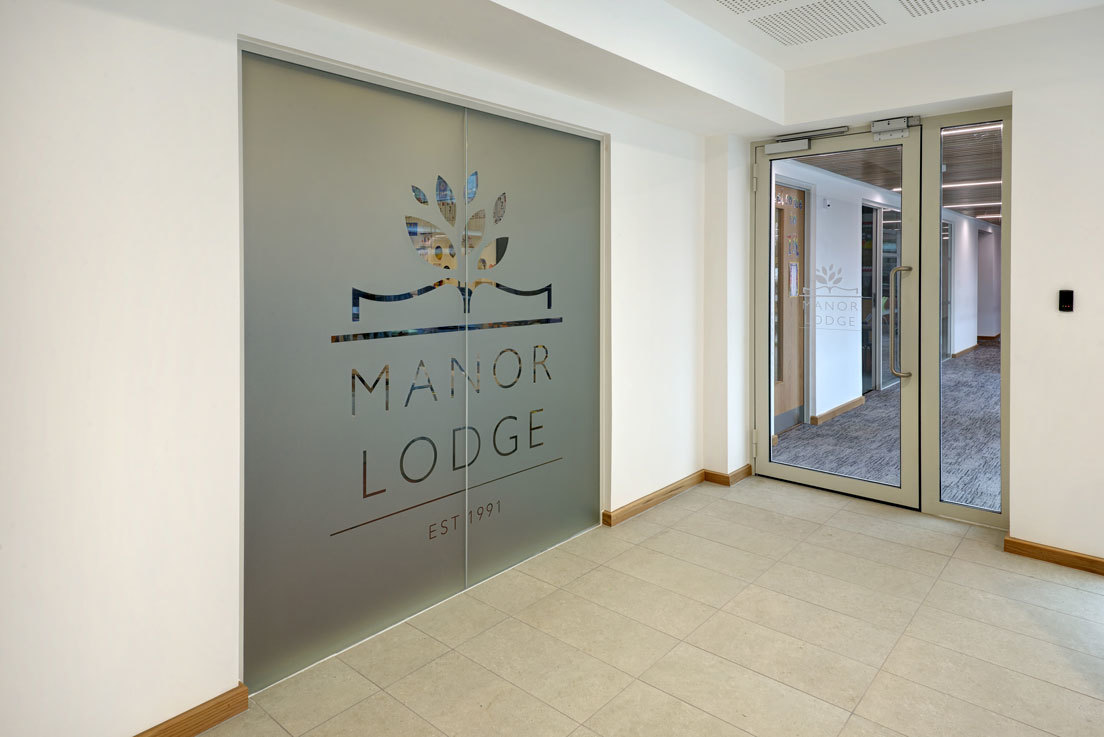 sliding glass door entrance into manor lodge school