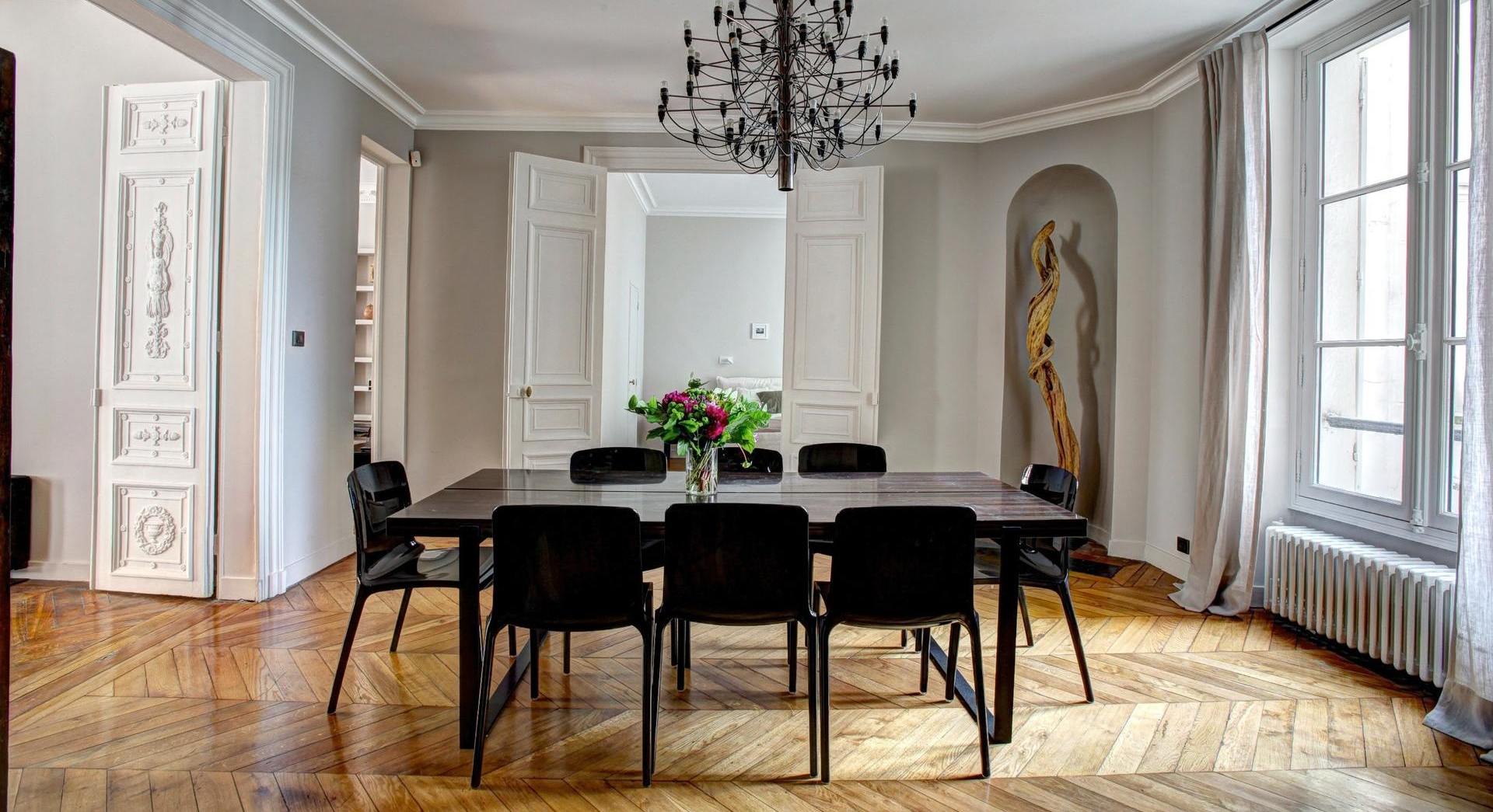 Luxury home dining room with feature light and parquet flooring