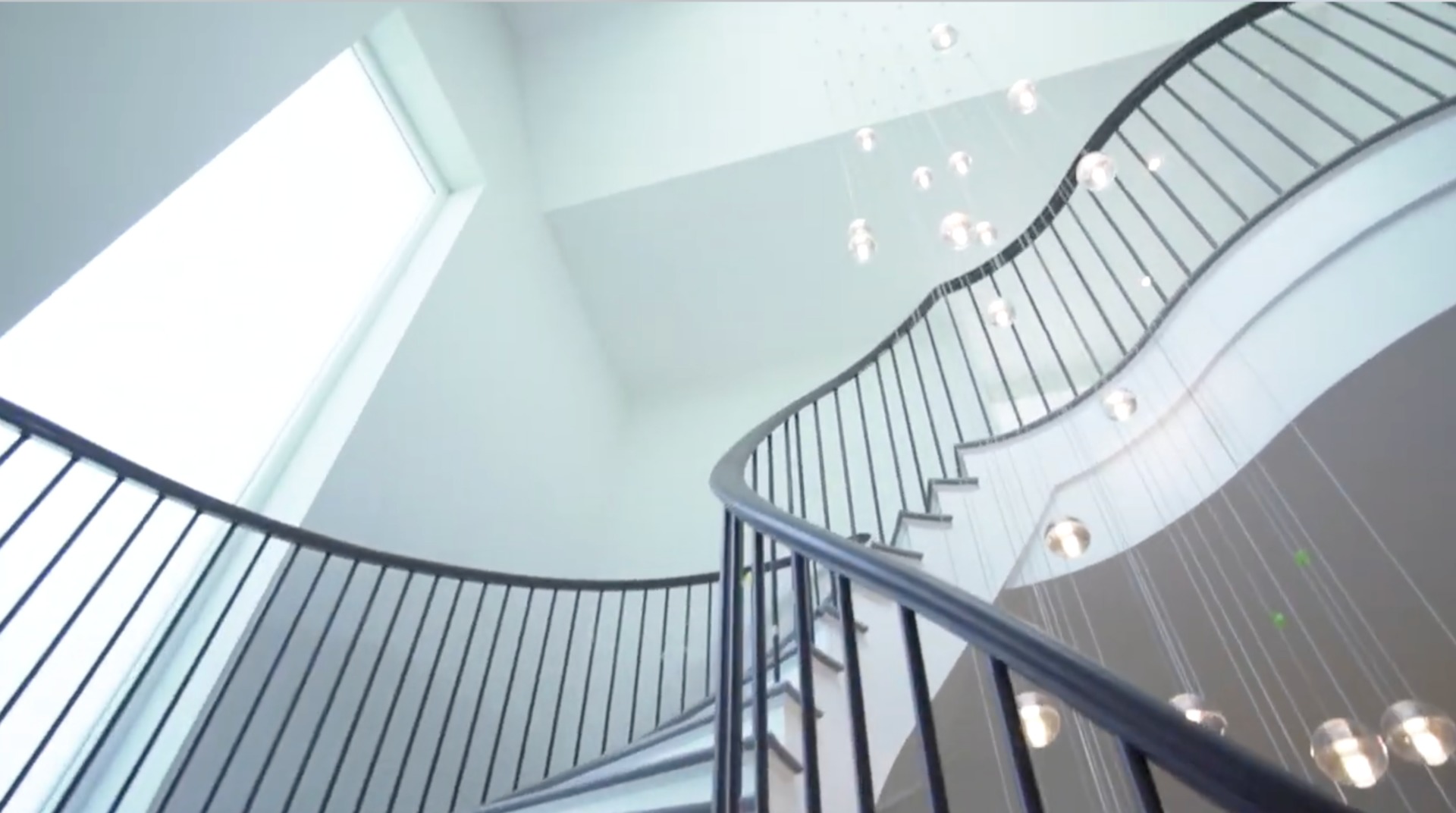 Custom curved stair with lighting feature and bespoke balustrade