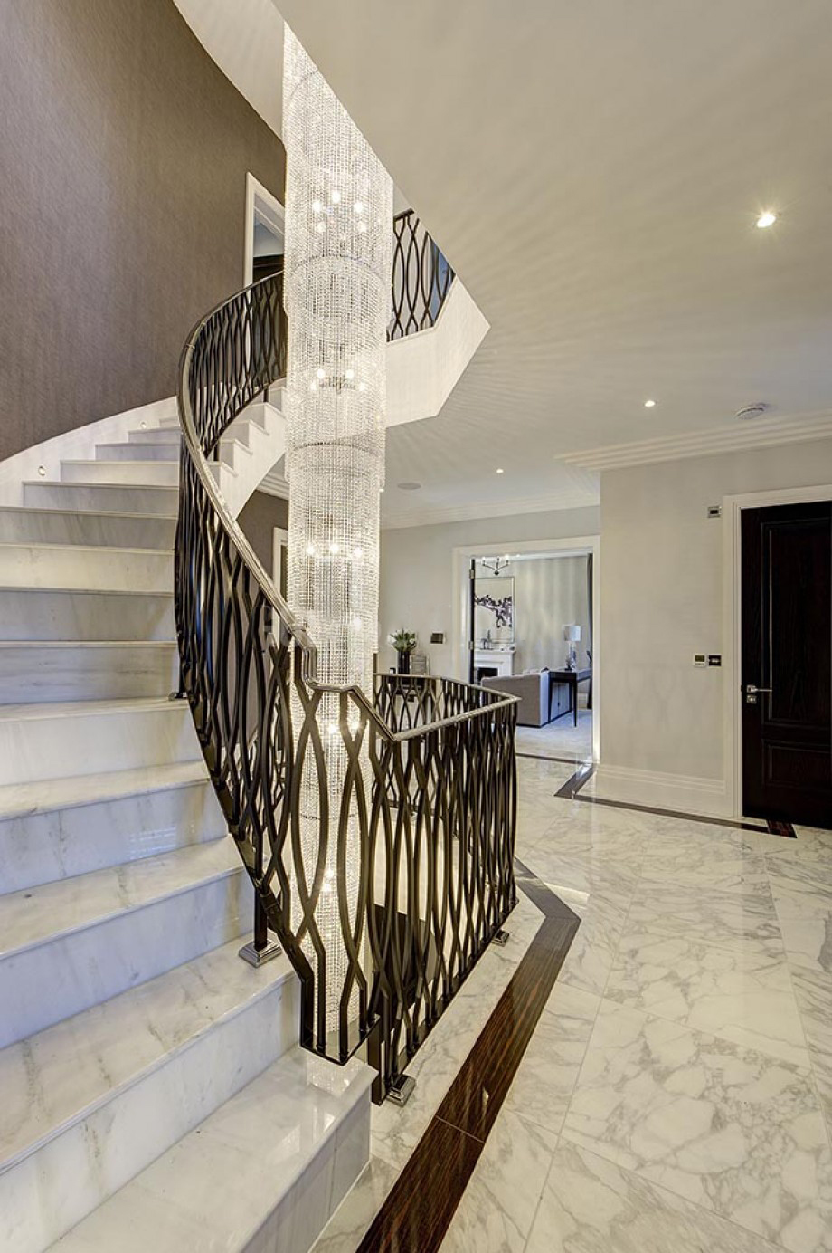 Custom curved stairs with lighting feature, marble flooring and bespoke balustrade