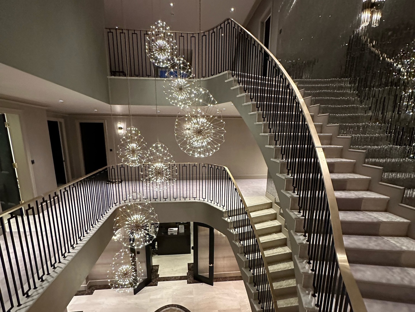 Two bespoke luxury staircases compliment entrance hall of luxury home