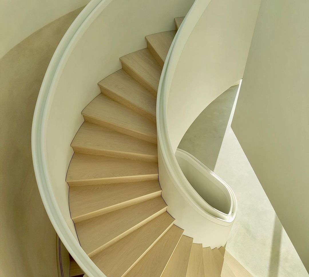 Luxury spiral staircase shown from above with handrails and timber treads