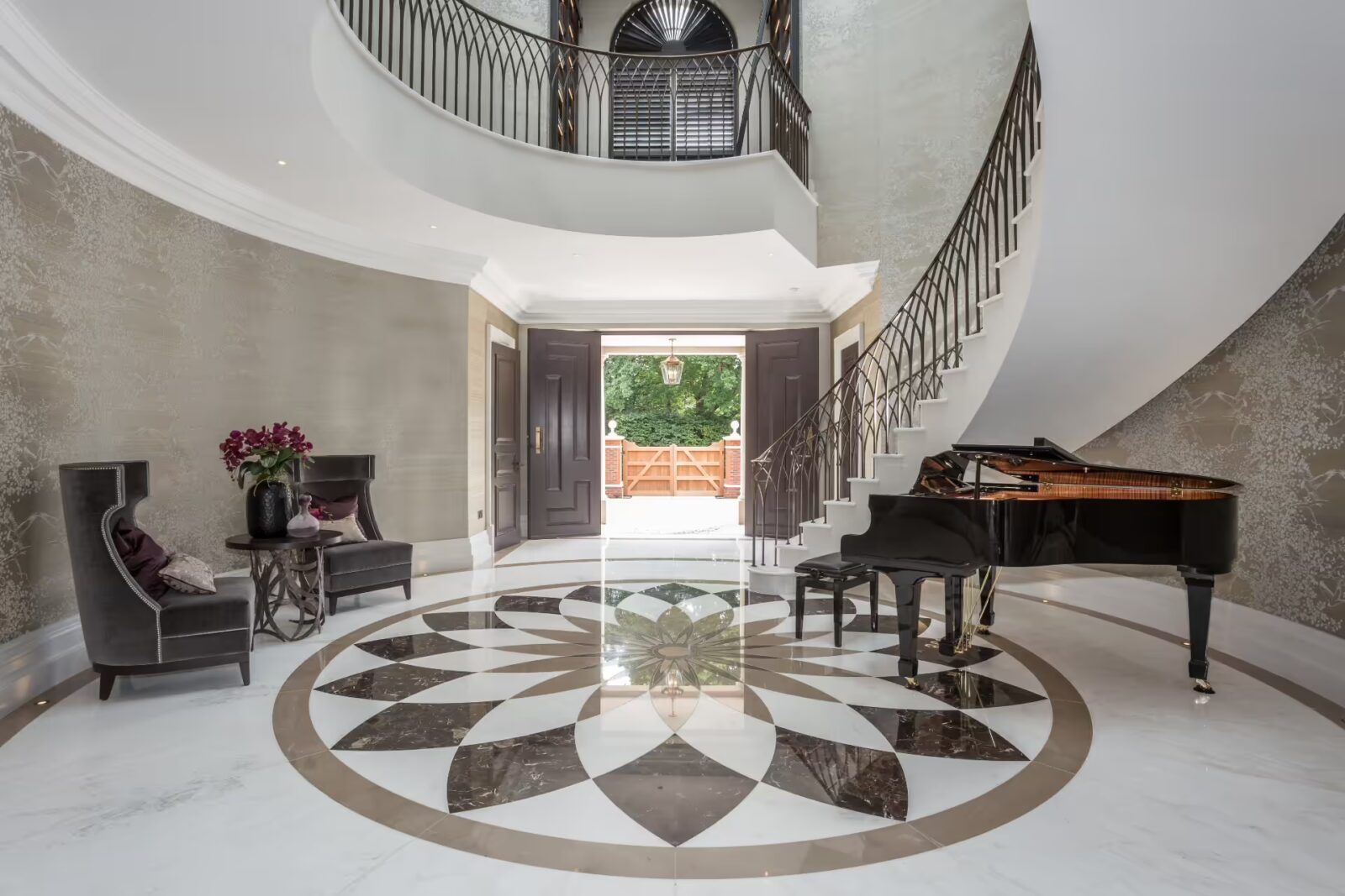 White marble entrance hall with curved helical staircase kings chase oxshott