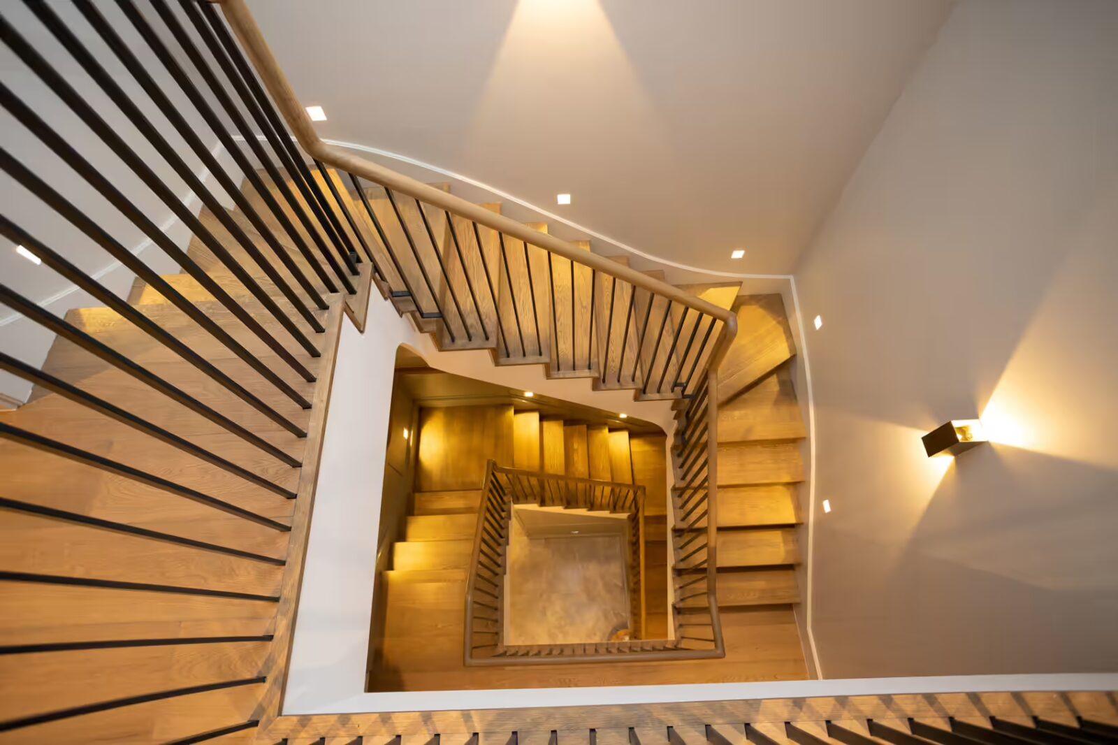 Winder staircases with wood cladding and timber handrails