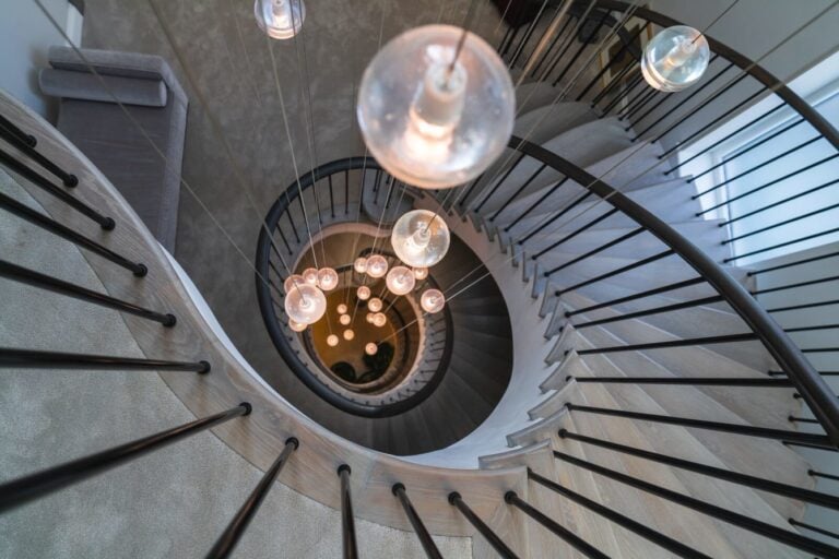 Aerial bview showing orb chandelier through void inside helical curved staircases Parkside Gardens Wimbledon