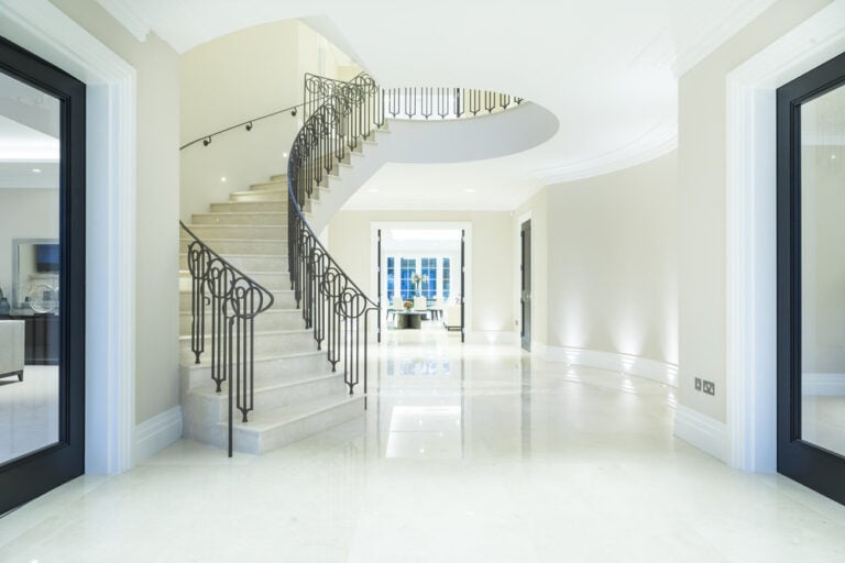Bespoke helical curved staircase in white marble with marble matching floor