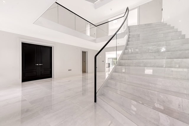 Close up view of marble clad luxury staircase Ridgeway Brentwood Essex