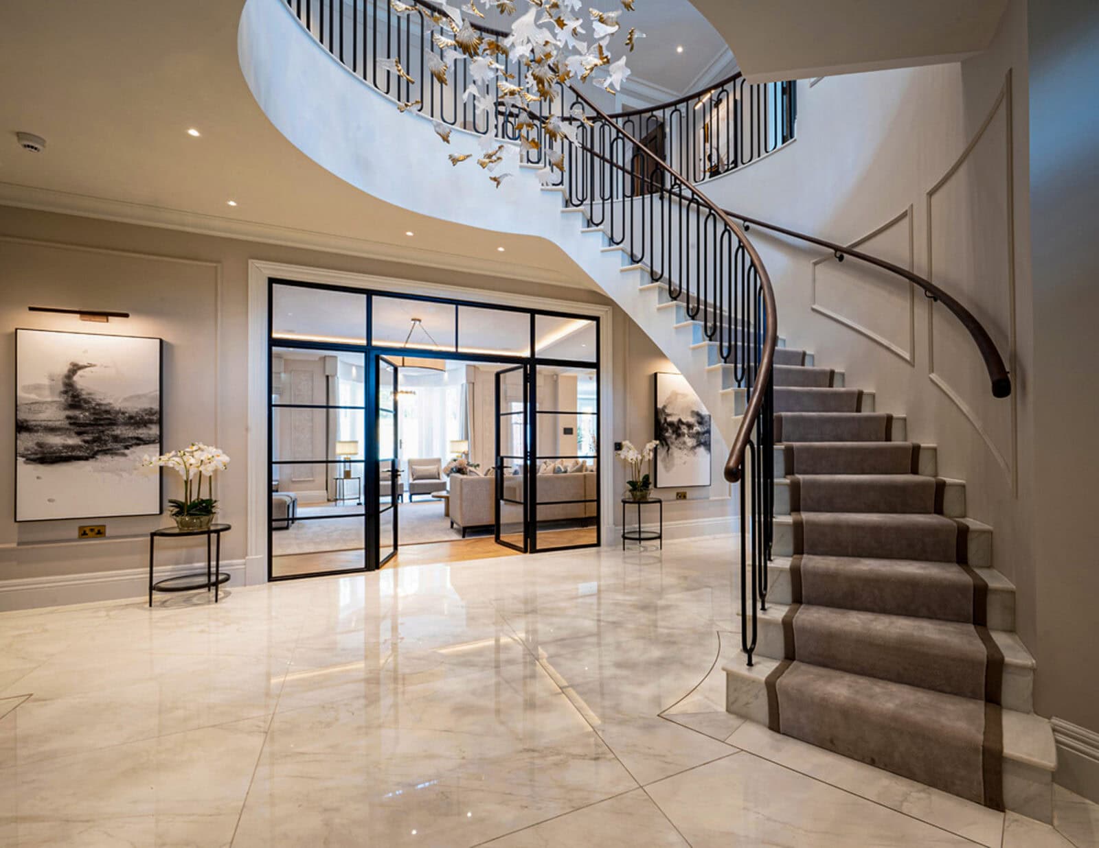 Entrance hall with luxury curved staircase and marble floor