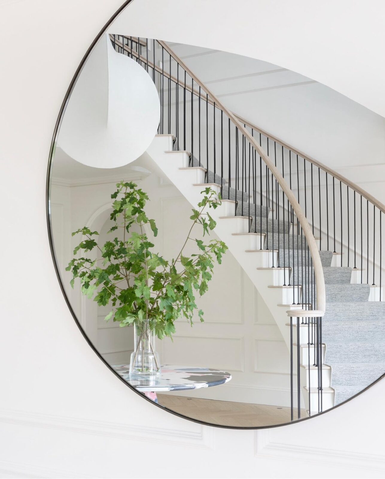 Reflection of luxury curved helical staircase in mirror