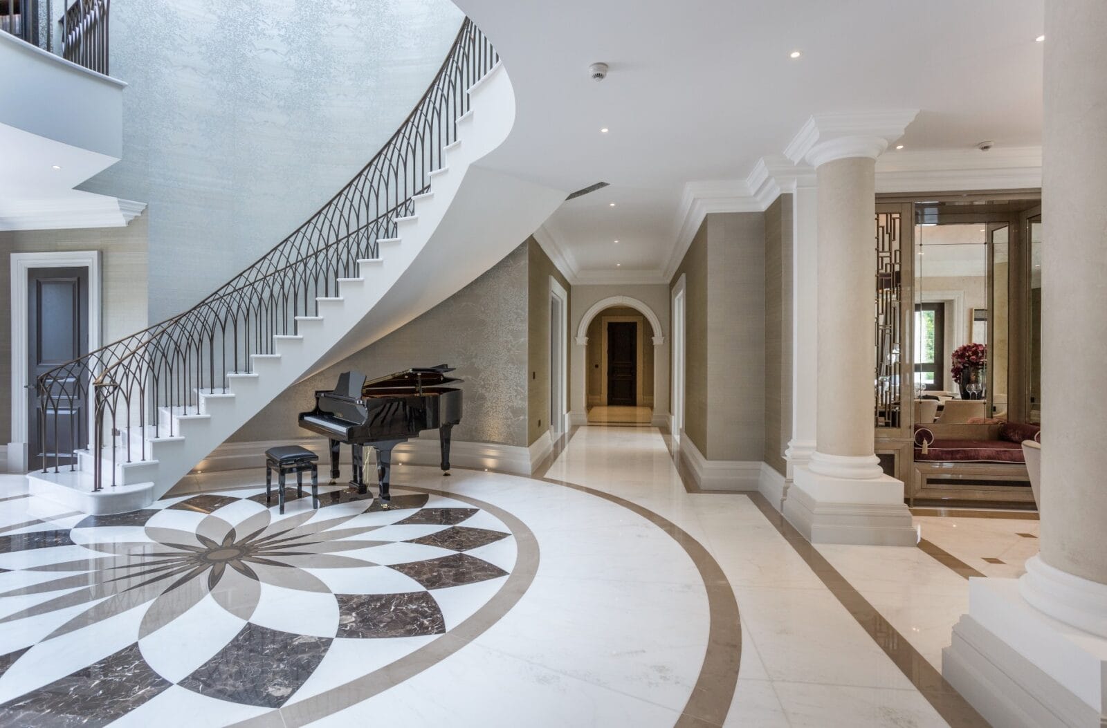 Side view of helical staircase columns and hallway of luxury home Kings Chase Oxshott