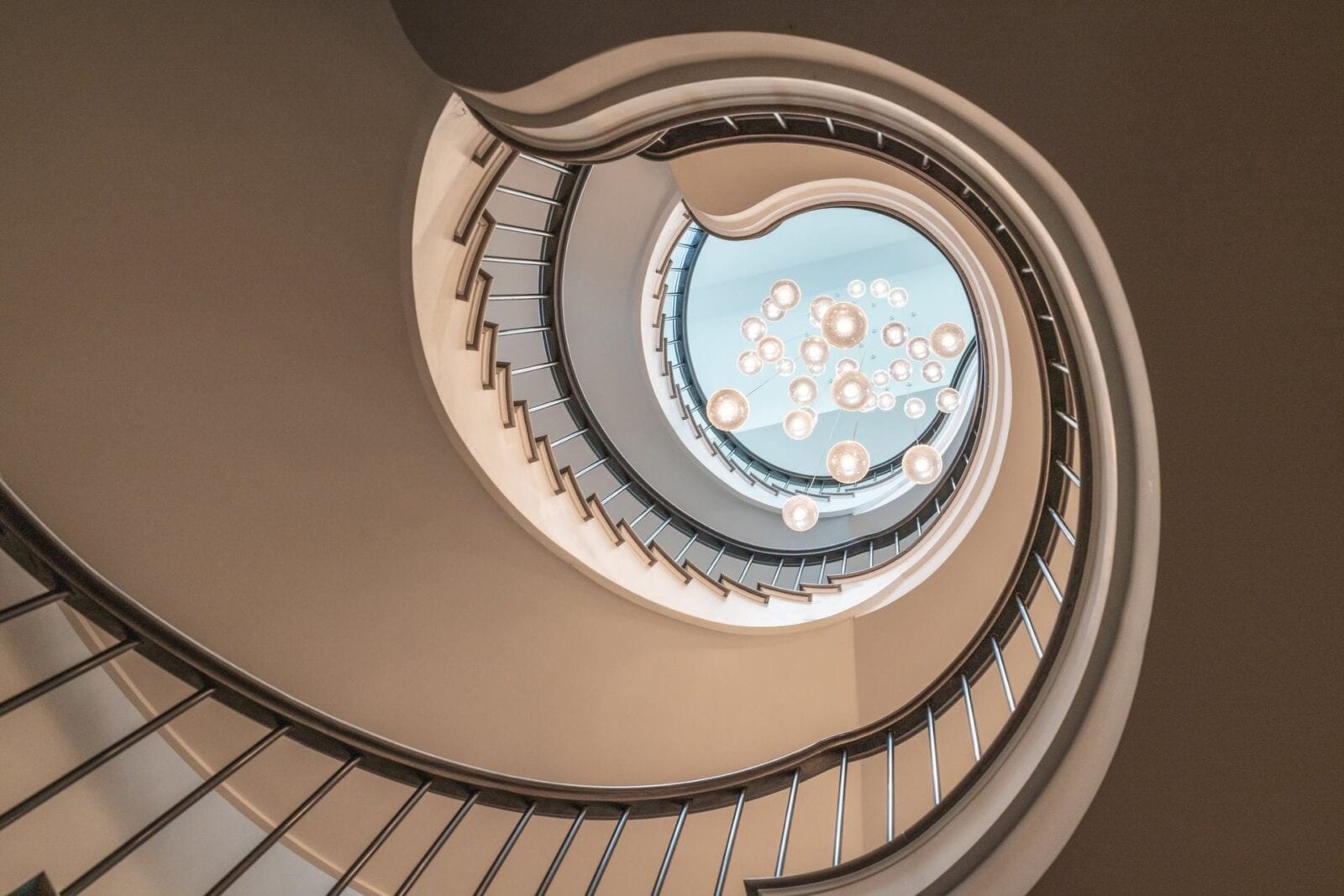 View of skylight and chandelier through central void of helical staircases Parkside Gardens Wimbledon