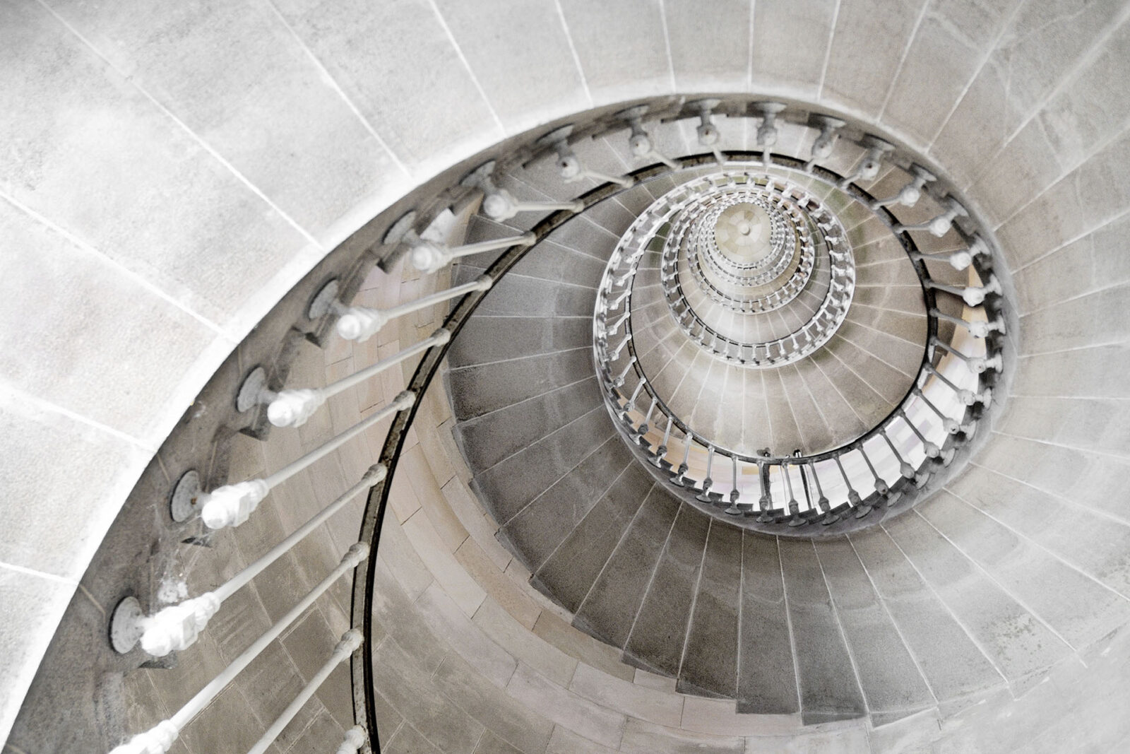 decorative spiral staircase with architectural handrail in stone
