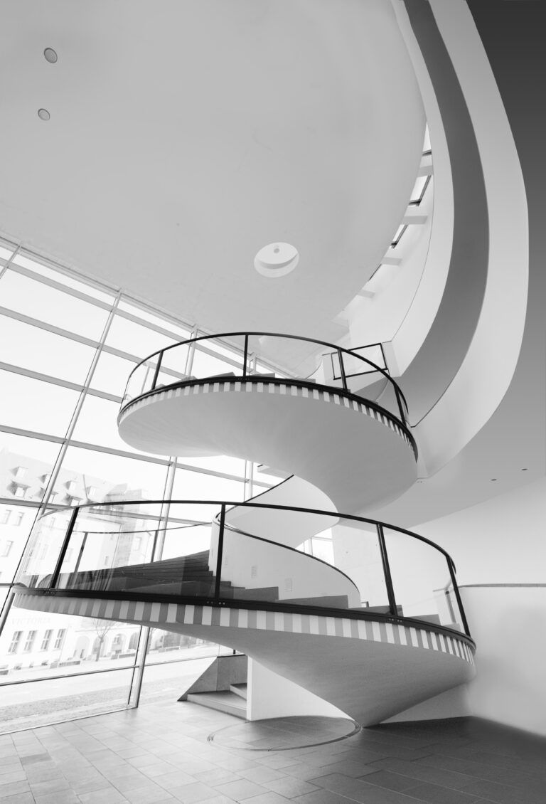 Black and white photo of white spiral staircase