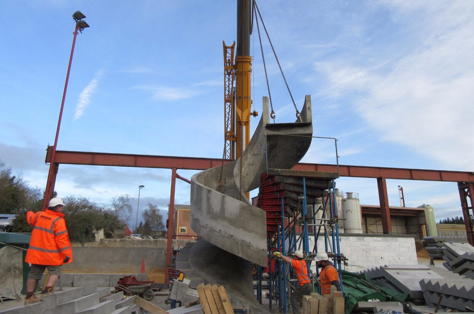 precast concrete staircase lifted from mould in factory yard with crane Denham Film studios Buckinghamshire