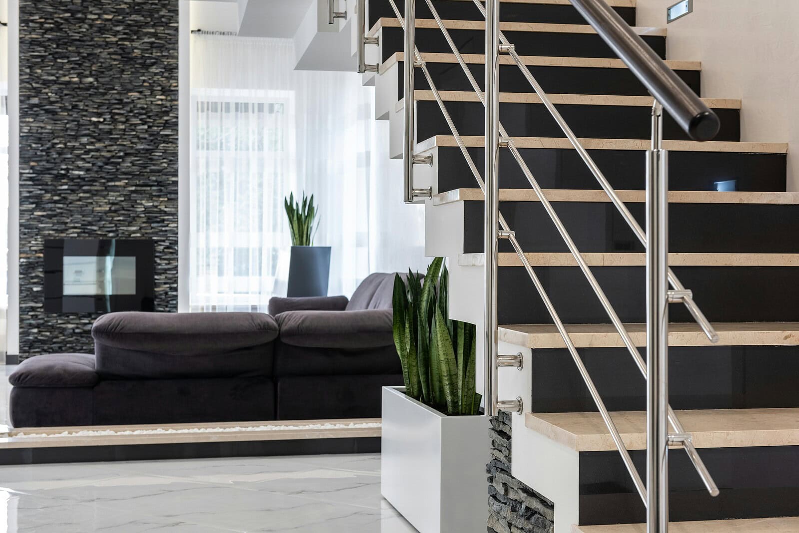 Marble beige and black staircase with metal ballustrade