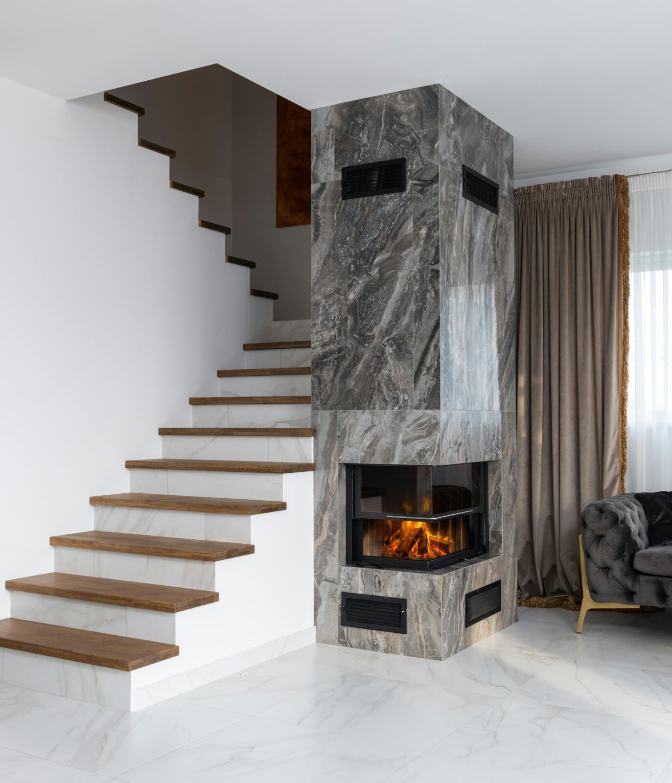 Wooden and marble stairs with a marble fireplace